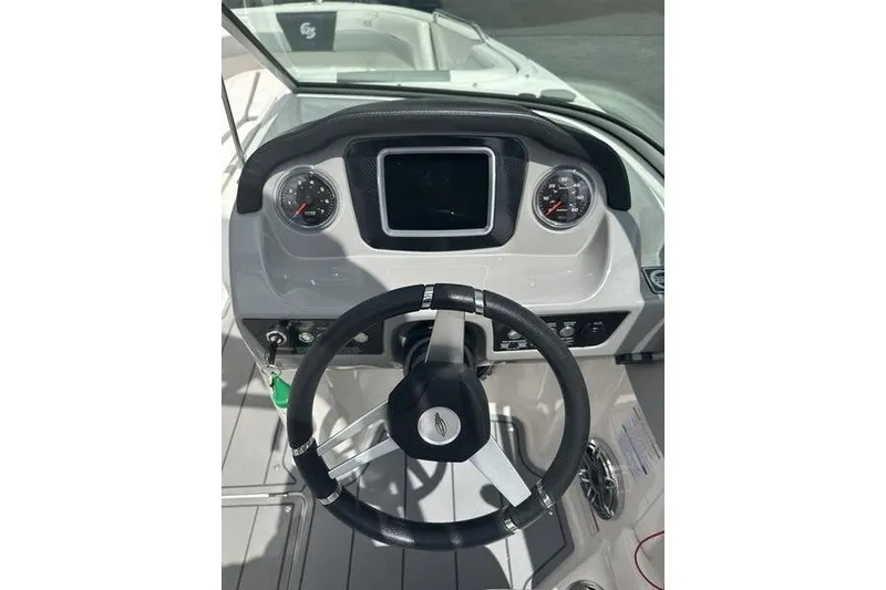 Slide: The Image of 2021 Chaparral 21 Surf boat dashboard with steering wheel and gauges. - 16