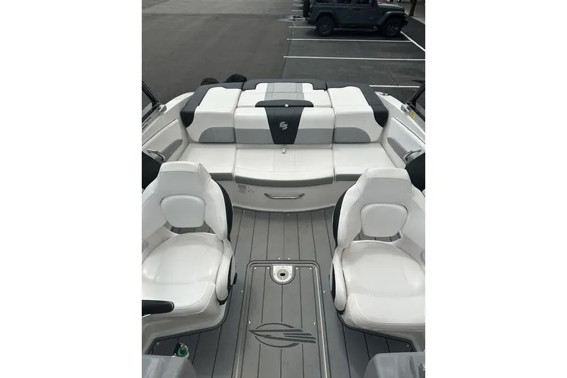 Slide: The Image of 2021 Chaparral 21 Surf boat interior with white seating and sleek design. - 17
