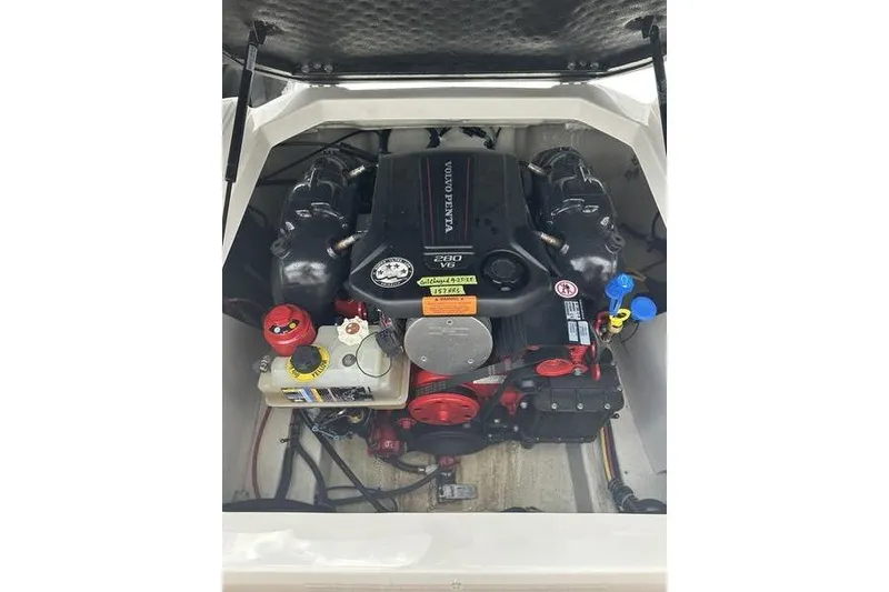 Slide: The Image of Engine compartment of a 2021 Chaparral 21 Surf boat, featuring a Volvo Penta engine. - 19