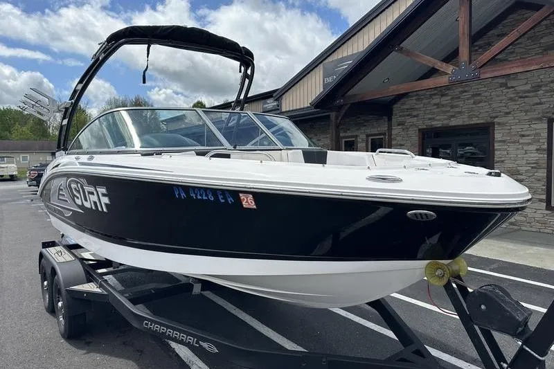 Slide: The Image of 2021 Chaparral 21 Surf boat on trailer, parked outside a building. - 3