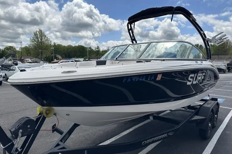 Slide: The Image of 2021 Chaparral 21 Surf boat on trailer under cloudy sky in parking lot. - 5