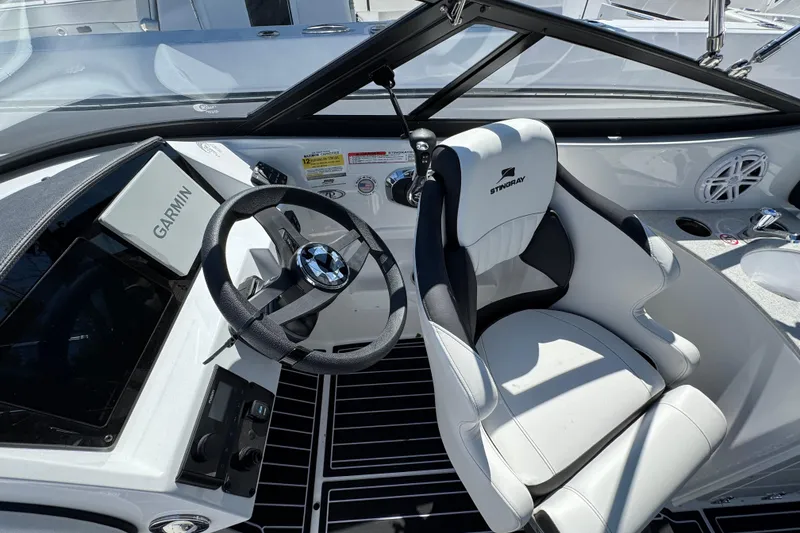 Slide: The Image of 2026 Stingray 231 DC boat cockpit with Garmin navigation and stylish seating. - 13