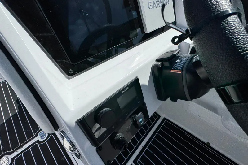 Slide: The Image of 2026 Stingray 231 DC boat dashboard with Garmin navigation system and controls. - 15