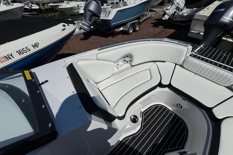 Slide: The Image of 2026 Stingray 231 DC boat interior with white seating and black flooring. - 22