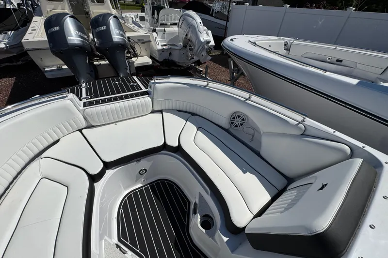 Slide: The Image of 2026 Stingray 231 DC boat interior with white seating and dual Yamaha engines. - 23