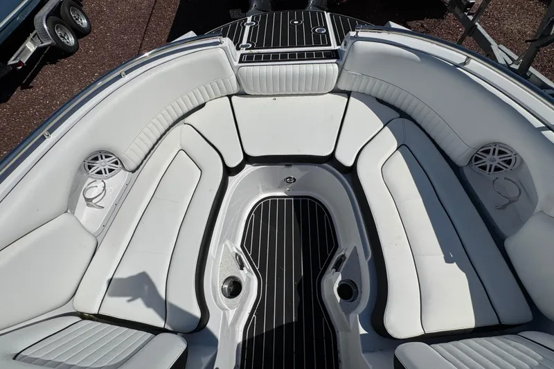 Slide: The Image of 2026 Stingray 231 DC boat interior with white seating and black flooring. - 24