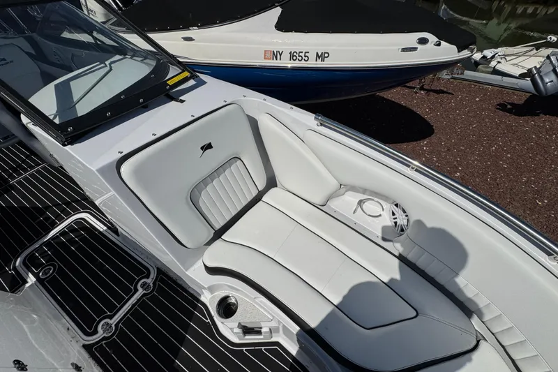 Slide: The Image of 2026 Stingray 231 DC boat interior with white seating and sleek design. - 26