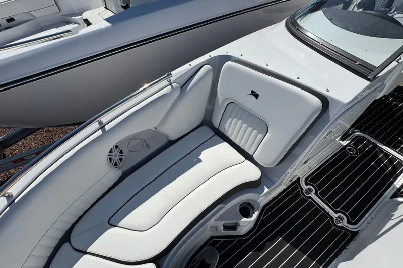 Slide: The Image of 2026 Stingray 231 DC boat interior with sleek white seating and modern design. - 27