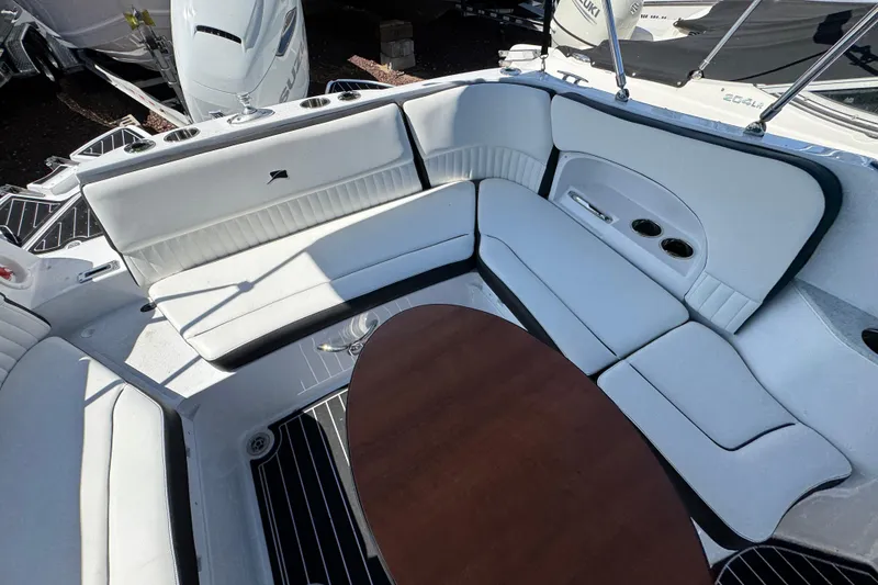 Slide: The Image of 2026 Stingray 231 DC boat interior with white seating and wooden table. - 32