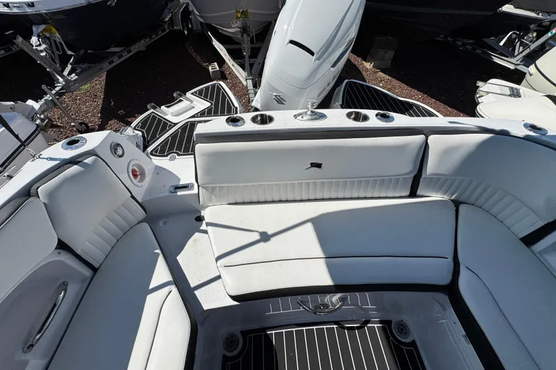 Slide: The Image of 2026 Stingray 231 DC boat interior with white seating and cup holders. - 33