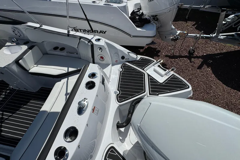Slide: The Image of 2026 Stingray 231 DC boat interior with seating and motor, showcasing sleek design and functionality. - 4