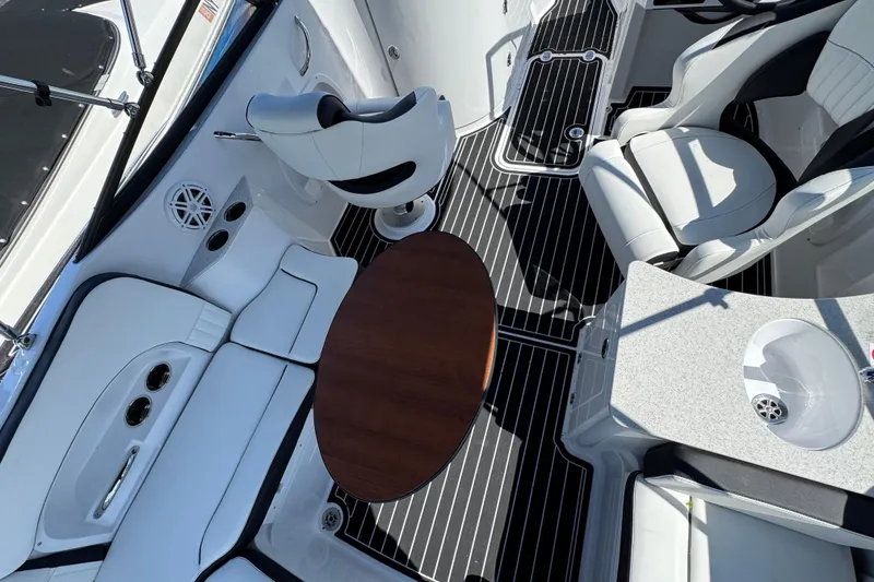 Slide: The Image of Interior of 2026 Stingray 231 DC boat with seating, table, and sink. - 6