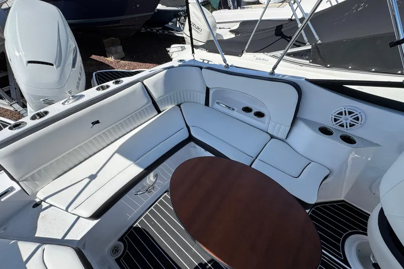 Slide: The Image of 2026 Stingray 231 DC boat interior with white seating and wooden table. - 7
