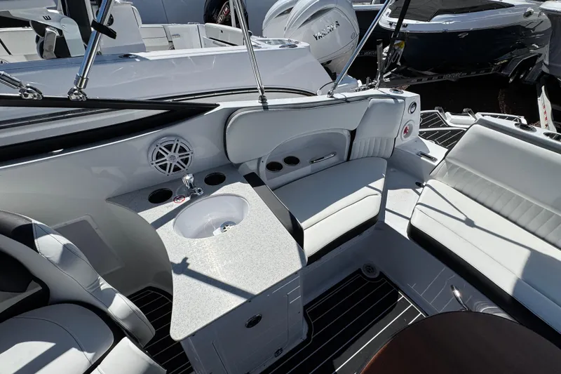 Slide: The Image of 2026 Stingray 231 DC boat interior with seating, sink, and modern design features. - 8