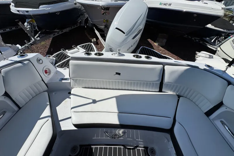 Slide: The Image of 2026 Stingray 231 DC boat interior with white seating and cup holders. - 9