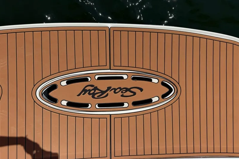 Slide: The Image of Teak deck of 2006 Sea Ray Sundancer 320 with logo, reflecting sunlight. - 20