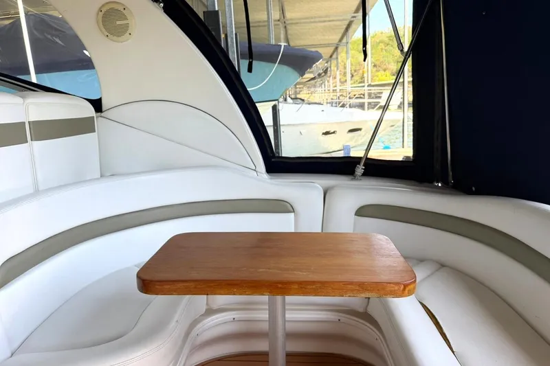 Slide: The Image of Interior of 2006 Sea Ray Sundancer 320 with white seating and wooden table. - 23