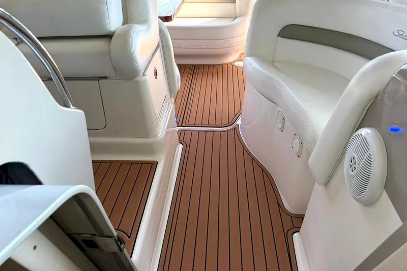 Slide: The Image of Interior of a 2006 Sea Ray Sundancer 320 with teak flooring and white seating. - 26