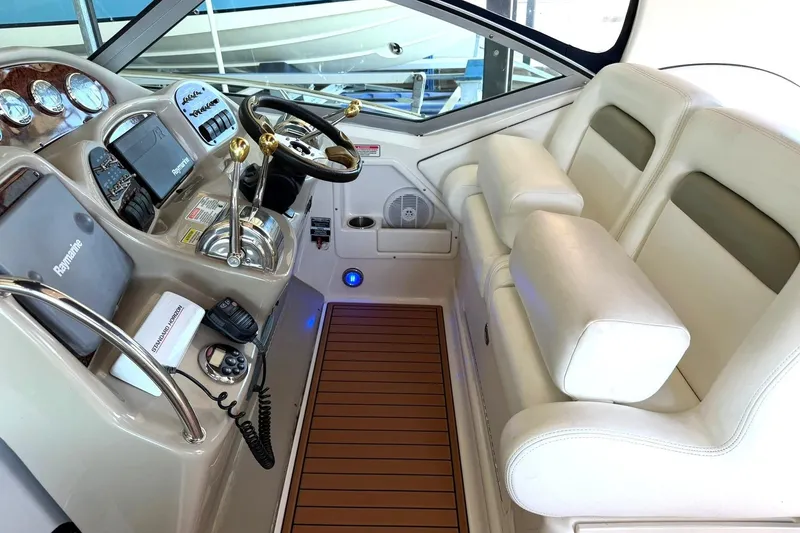 Slide: The Image of Cockpit of 2006 Sea Ray Sundancer 320 with steering wheel and navigation controls. - 28