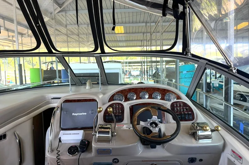 Slide: The Image of Cockpit view of a 2006 Sea Ray Sundancer 320 with navigation equipment and steering wheel. - 29