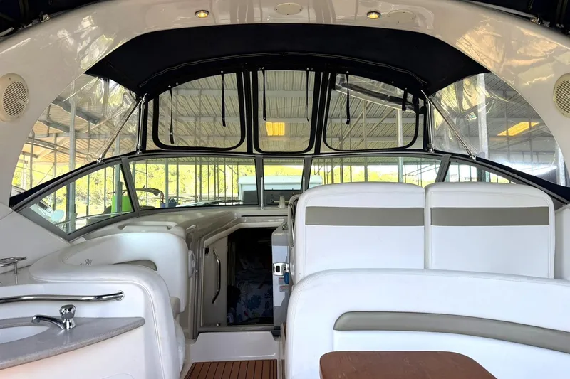 Slide: The Image of Interior view of a 2006 Sea Ray Sundancer 320 yacht, featuring sleek seating and helm. - 3