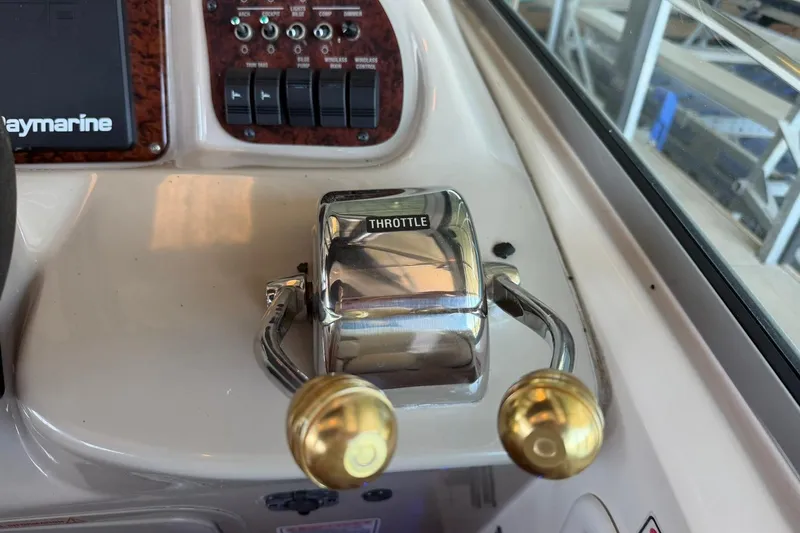 Slide: The Image of Throttle controls on a 2006 Sea Ray Sundancer 320 boat dashboard. - 31