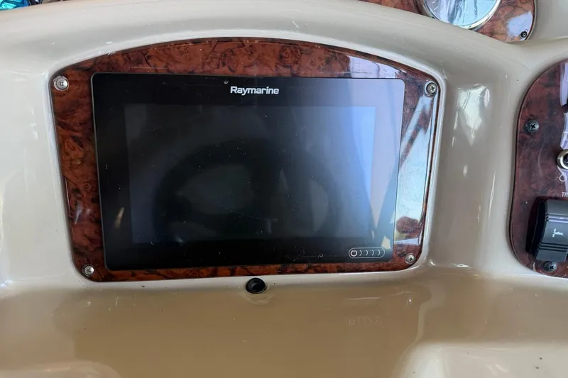 Slide: The Image of Raymarine display on 2006 Sea Ray Sundancer 320 dashboard with wood trim. - 32