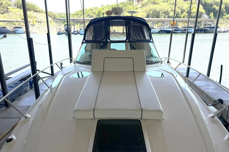 Slide: The Image of 2006 Sea Ray Sundancer 320 yacht docked, showcasing sleek design and spacious deck. - 33