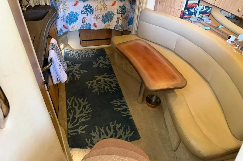 Slide: The Image of Interior of 2006 Sea Ray Sundancer 320 with cozy seating and nautical decor. - 38