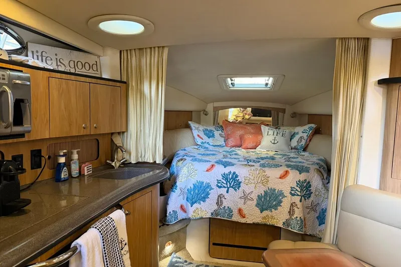 Slide: The Image of Luxurious 2006 Sea Ray Sundancer 320 cabin interior with cozy bed and kitchenette. - 39