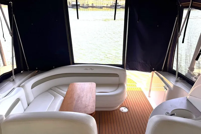 Slide: The Image of Interior of 2006 Sea Ray Sundancer 320 with white seating and wooden table. - 4