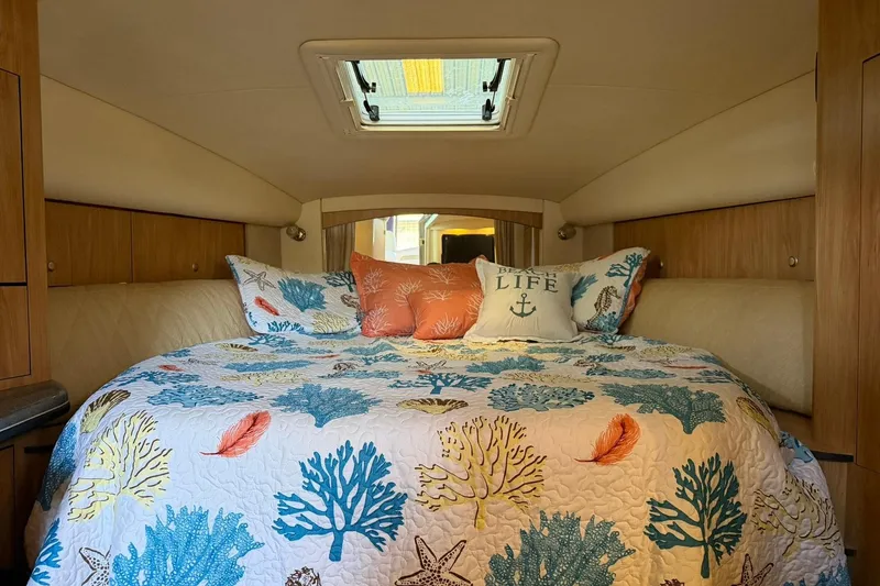 Slide: The Image of Cozy cabin interior of 2006 Sea Ray Sundancer 320 with nautical-themed bedding. - 40