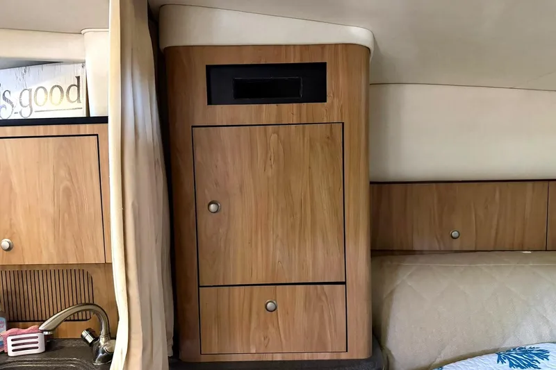 Slide: The Image of Interior of 2006 Sea Ray Sundancer 320, featuring wooden cabinetry and a compact sink area. - 41