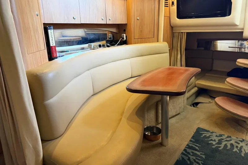 Slide: The Image of Interior of 2006 Sea Ray Sundancer 320 with beige seating and wooden table. - 44