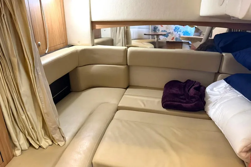 Slide: The Image of Interior cabin of 2006 Sea Ray Sundancer 320 with beige seating and cozy bedding. - 46