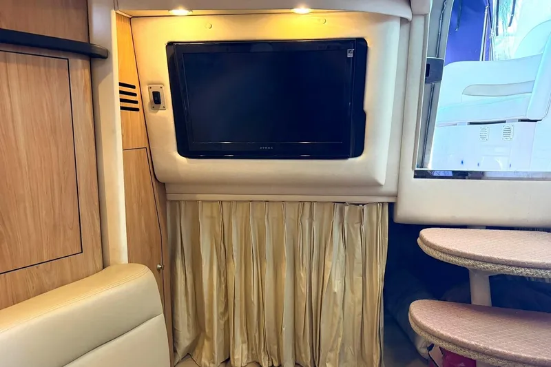 Slide: The Image of Interior of 2006 Sea Ray Sundancer 320 with TV, wood paneling, and seating area. - 47