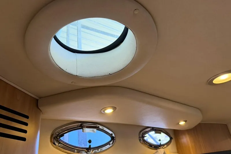 Slide: The Image of Interior view of 2006 Sea Ray Sundancer 320 with circular and oval windows. - 49