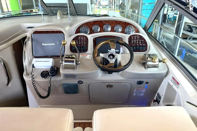 Slide: The Image of Helm of 2006 Sea Ray Sundancer 320 with Raymarine navigation system and classic wood accents. - 5