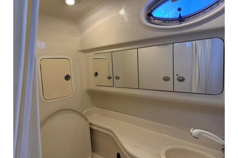 Slide: The Image of Bathroom interior of 2006 Sea Ray Sundancer 320 yacht with mirrored cabinets and porthole window. - 50