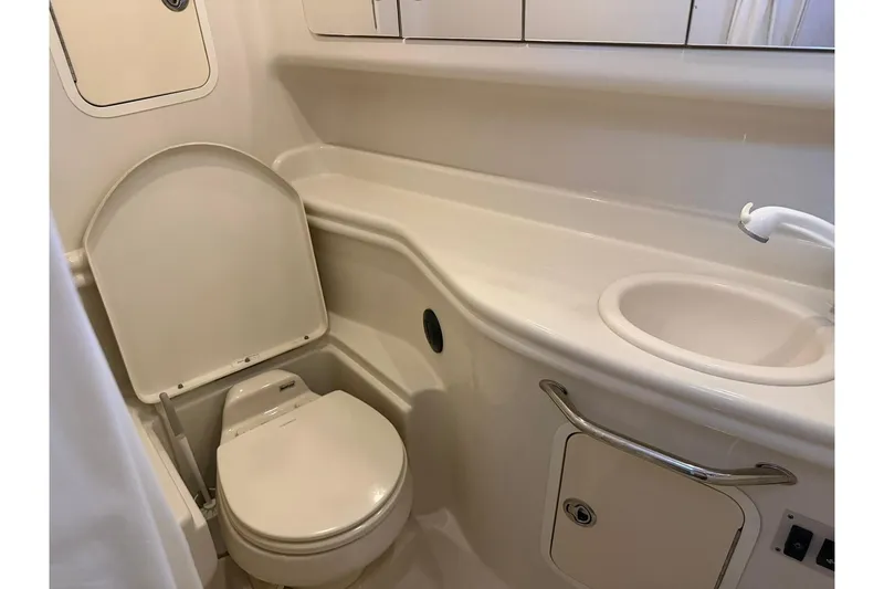Slide: The Image of 2006 Sea Ray Sundancer 320 bathroom with toilet, sink, and storage compartments. - 51