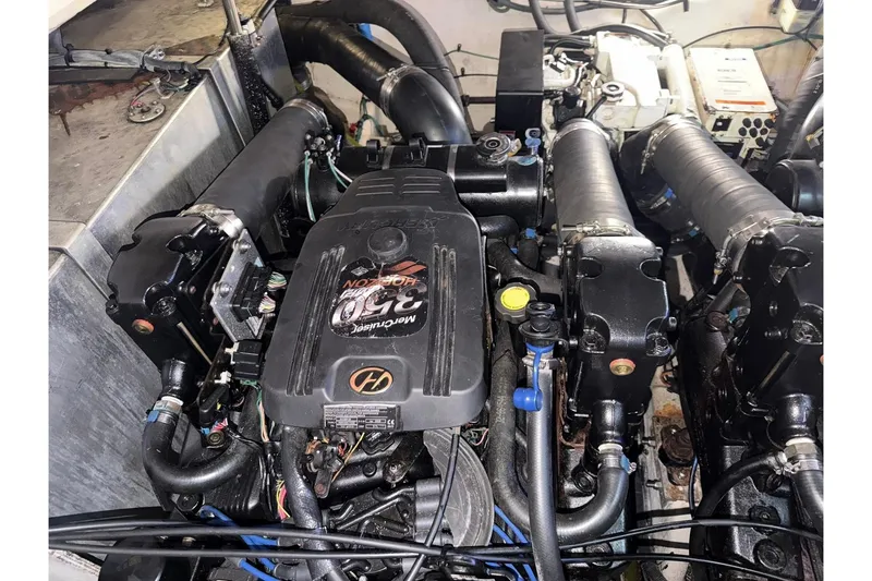 Slide: The Image of Engine compartment of a 2006 Sea Ray Sundancer 320 boat, featuring a MerCruiser 350 engine. - 53