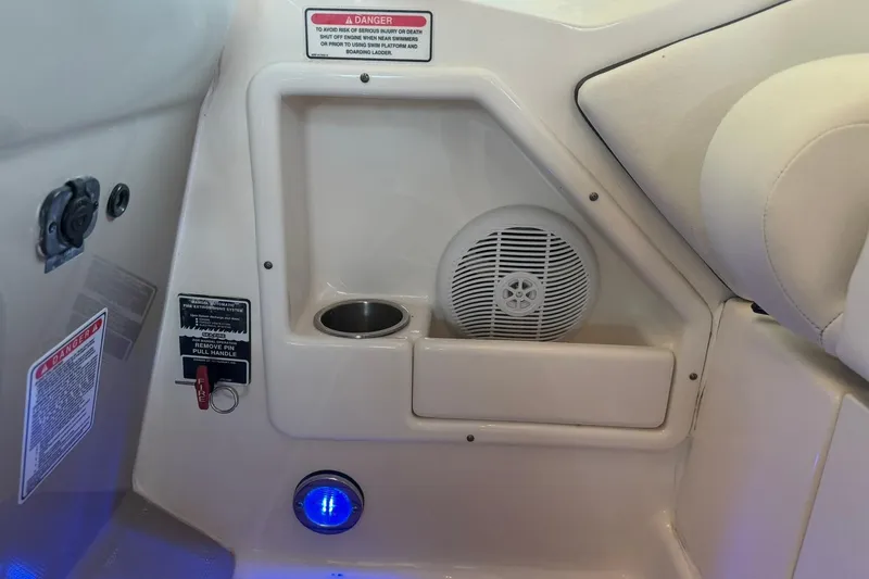 Slide: The Image of Interior of a 2006 Sea Ray Sundancer 320 boat, featuring a speaker and cup holder. - 57