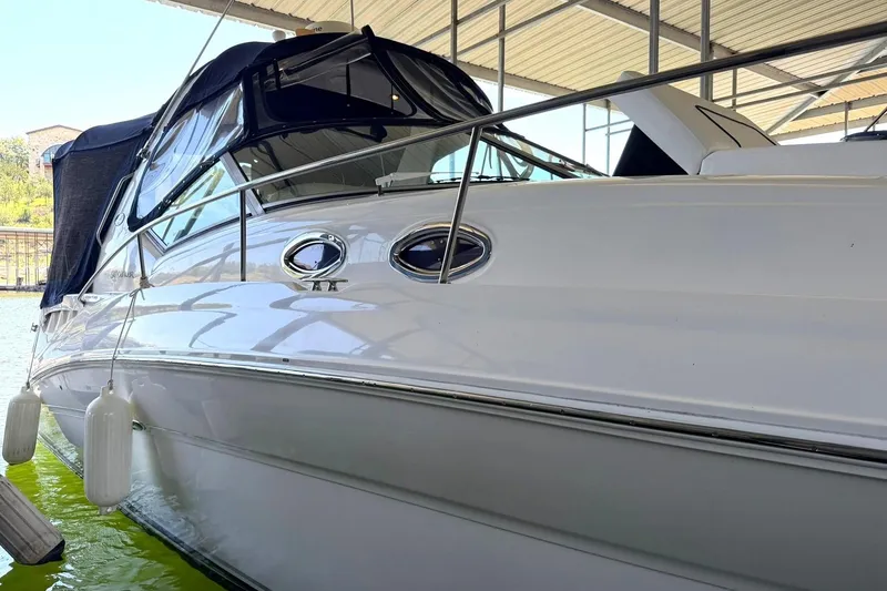 Slide: The Image of 2006 Sea Ray Sundancer 320 docked under a covered marina. - 59