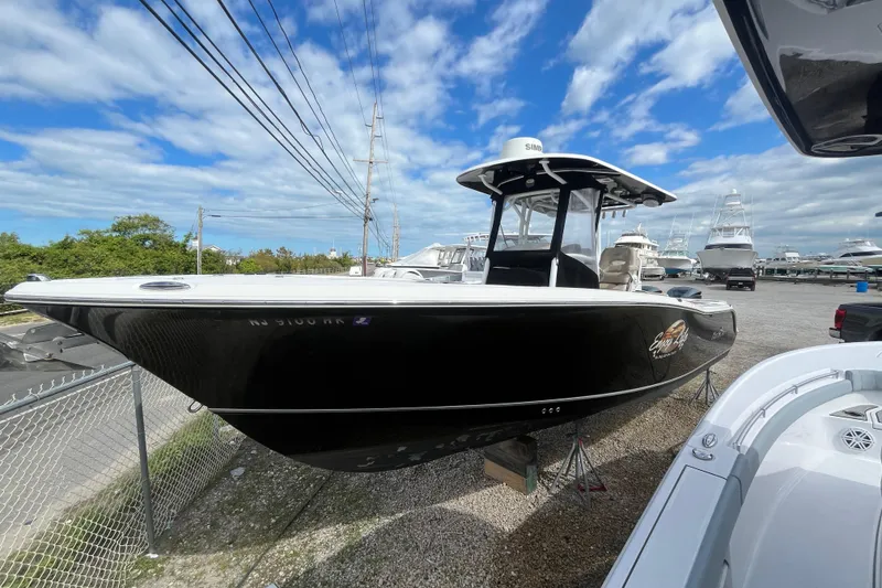 The Image of 2017 NauticStar 28 XS boat displayed outdoors under a blue sky. - 0