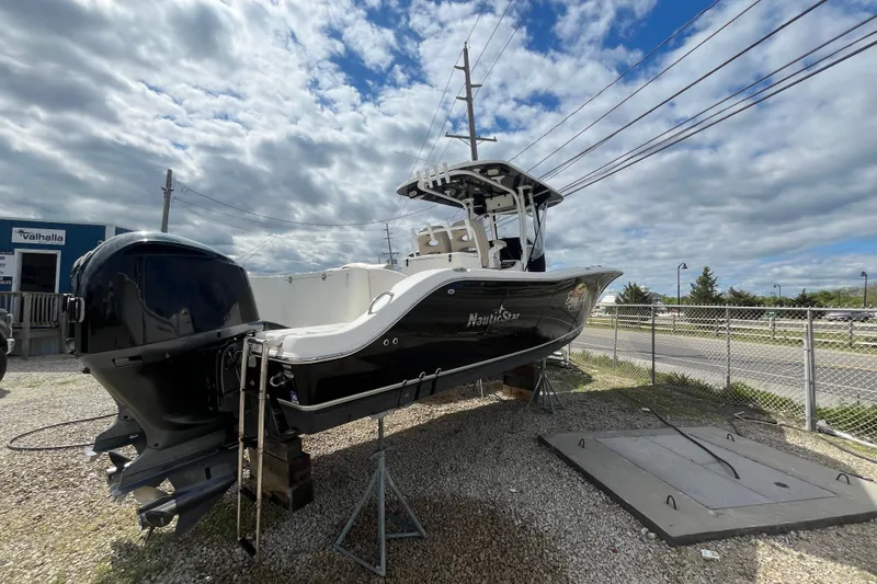 Slide: The Image of 2017 NauticStar 28 XS boat on display under a cloudy sky. - 1