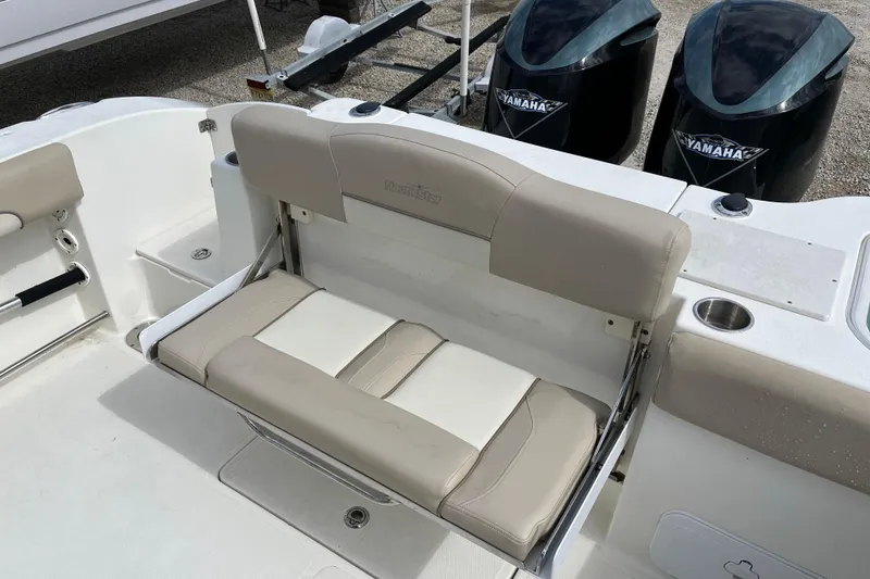 Slide: The Image of 2017 NauticStar 28 XS boat with beige seating and dual Yamaha engines. - 10