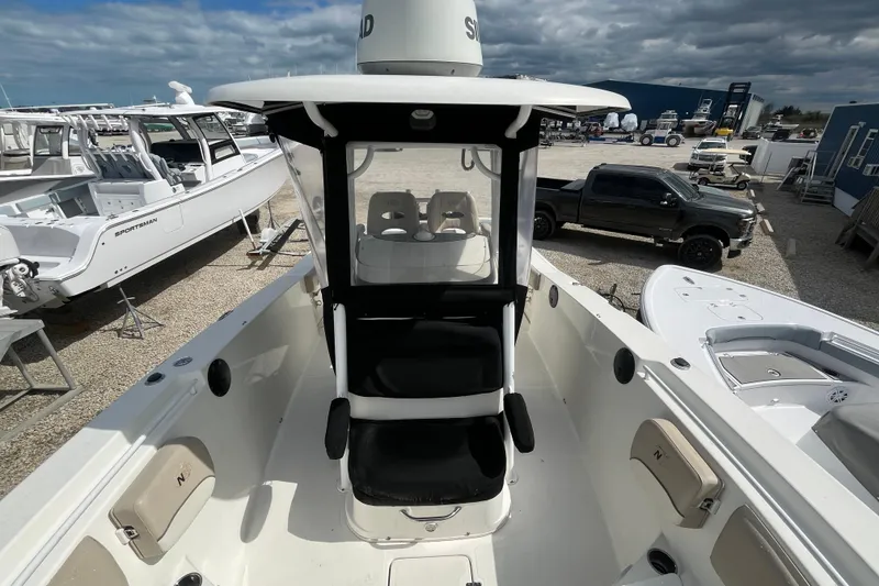 Slide: The Image of 2017 NauticStar 28 XS boat interior with seating, parked in a marina. - 11