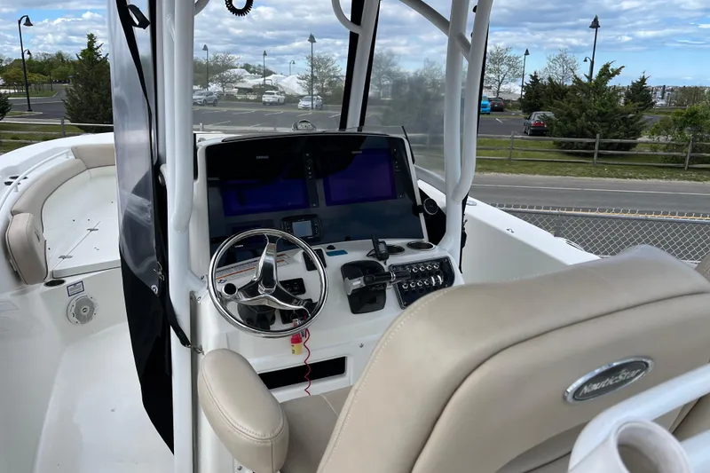 Slide: The Image of 2017 NauticStar 28 XS boat cockpit with steering wheel and navigation screens. - 4