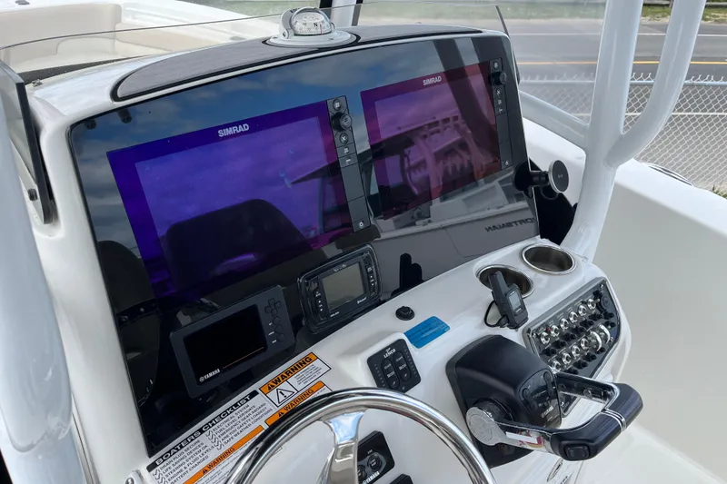 Slide: The Image of Dashboard of 2017 NauticStar 28 XS boat with Simrad navigation displays. - 5