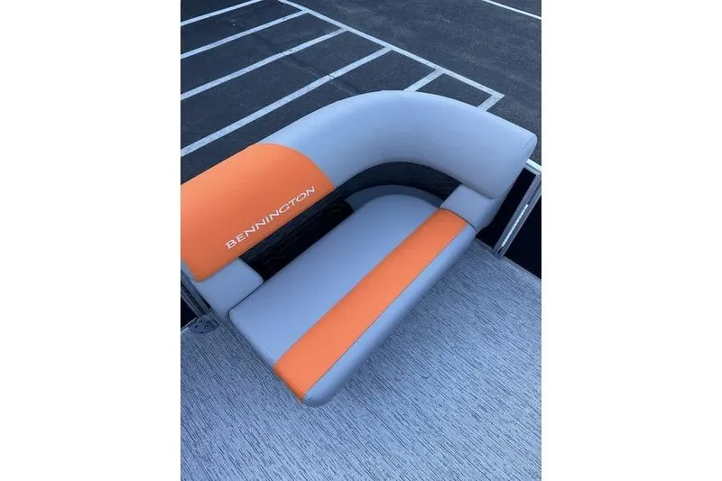 Slide: The Image of 2026 Bennington S L-Bench 168 SLJ with orange and gray seating on a boat deck. - 11